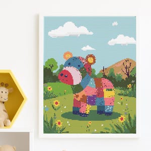 May include: A framed cross-stitch art piece featuring a colorful patchwork animal, likely a horse or donkey, standing in a field with flowers. The background includes a blue sky with clouds and a green landscape.