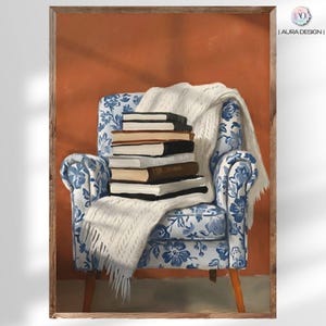 May include: A framed print of a cozy reading scene. A blue and white floral armchair holds a stack of books and a white knitted throw blanket. The background is a warm orange-brown color.