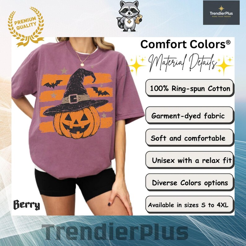 Puede incluir: Una camiseta color baya con un gr&aacute;fico de una calabaza naranja con un sombrero de bruja negro, sobre rayas horizontales naranjas y murci&eacute;lagos negros. La camiseta incluye etiquetas de texto para Comfort Colors y 100% algod&oacute;n.