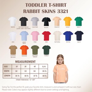 May include: A color chart for Rabbit Skins 3321 toddler t-shirts featuring twenty solid color options including white, black, heather, peachy, gold, kelly, ash, light blue, pink, red, natural, royal, navy, coyote brown, orange, military green, and forest.
