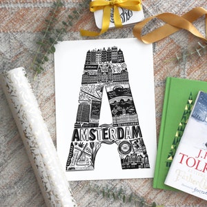 May include: Black and white illustration of the letter A, made up of images of Amsterdam landmarks, with the word "AMSTERDAM" written below. The illustration is on a white background.