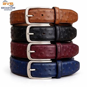 May include: A stack of four leather belts in various colors: brown, black, burgundy, and blue. Each belt features a silver-colored buckle and a textured surface with small, evenly spaced dots. The belts are stacked on top of each other.