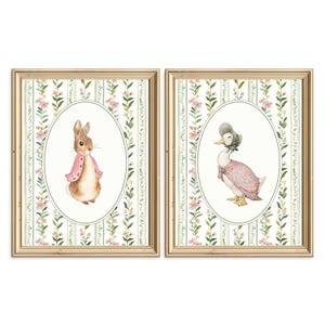 May include: Two framed watercolor prints featuring a bunny and a duck. The bunny wears a pink jacket, and the duck wears a bonnet and dress. Both are set against a floral and striped background, framed in gold.