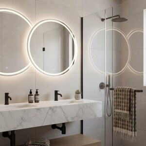 May include: Modern bathroom with two illuminated circular mirrors above a marble countertop with black faucets. A glass shower enclosure with a rain shower head and a towel rack with a patterned towel are visible. A wooden shelf holds folded towels.