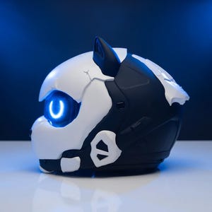May include: A futuristic helmet in black and white, with a glowing blue eye and accents. The helmet has a sleek, angular design, with a prominent ear and a smooth, reflective surface. The background is a gradient of dark blue.