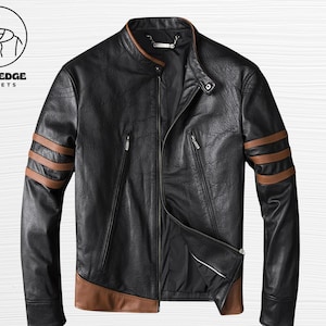 May include: Black leather jacket with brown accents on the sleeves and lower hem. The jacket has a zipper closure, a stand-up collar, and two zippered pockets. The brand logo "BOLD EDGE JACKETS" is in the upper left corner.