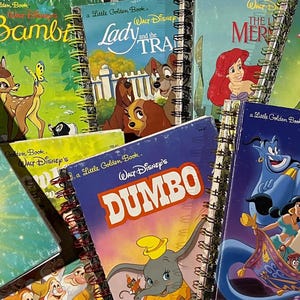 May include: A collection of spiral-bound notebooks featuring classic Disney Little Golden Book covers, including titles such as Bambi, Lady and the Tramp, The Little Mermaid, Peter Pan, Dumbo, and Aladdin, showcasing colorful character illustrations.