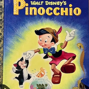 May include: A Little Golden Book titled Walt Disney's Pinocchio with a blue cover featuring the character Pinocchio, a black and white cat, and a goldfish in a bowl. The title is printed in large yellow letters at the top of the book cover.