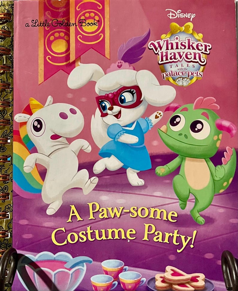May include: A Disney Whisker Haven Tales with the Palace Pets Little Golden Book titled A Paw-some Costume Party! featuring a white unicorn, a white puppy in a blue dress and pink mask, and a green dragon character on a pink background.
