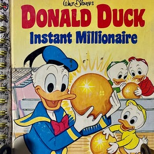 May include: A Little Golden Book titled Walt Disney's Donald Duck Instant Millionaire. The yellow cover features Donald Duck and three ducklings holding glowing golden spheres. The title is printed in large red and blue lettering.