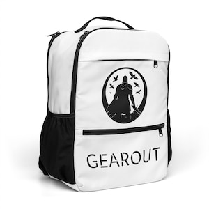 May include: White backpack with black accents, featuring a black graphic of a cloaked figure with a sword inside a circle with birds. The word "GEAROUT" is printed in black block letters on the front.