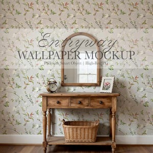 May include: A wooden entryway table with a mirror, alarm clock, and framed picture against a floral wallpaper backdrop. The table has three drawers and a woven basket below. The wallpaper has a light gray background with a floral pattern.