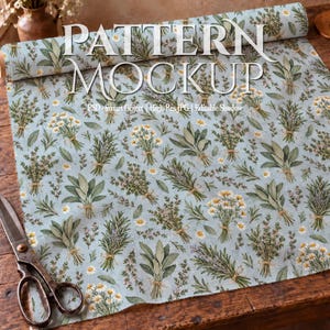 May include: A light blue fabric roll featuring a repeating botanical pattern of tied herb bundles and white daisy flowers. The text "PATTERN MOCKUP" is printed in white across the top, with "PSD - Smart Object | High-Res JPG | Editable Shadow" below.