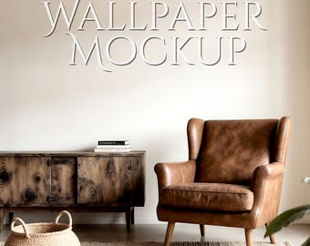 May include: A room interior featuring a brown leather armchair, a wooden cabinet, and a woven basket on a rug. The wall displays the text "WALLPAPER MOCKUP" in a white, stylized font. The scene evokes a cozy, rustic aesthetic.