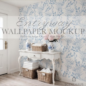 May include: A white entryway scene with a floral wallpaper backdrop. A white table with a drawer holds two vases with blue floral designs, a wicker basket, and a bouquet of pink flowers. Two wicker baskets with white towels are below. The text "Entryway Wallpaper Mockup" is visible.