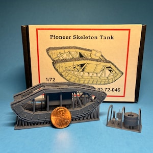 May include: A gray Pioneer Skeleton Tank model kit, scale 1/72, with a penny for size comparison. The box behind the model has an illustration of the tank. Additional model parts are also included.