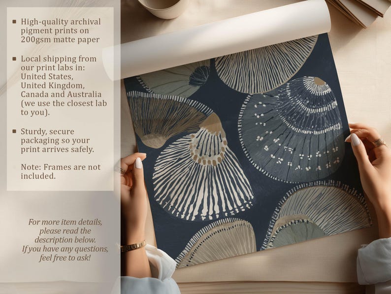 Textured seashell art print in navy and neutral beige, shown being unrolled on a tabletop beside a cup with an overlay about matte paper and secure packaging.