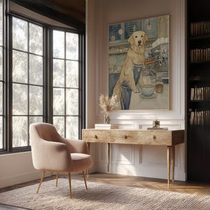 Modern barista dog art print in soft watercolors, large framed above a rustic wooden desk in a bright home office with built-in bookshelves and a blush chair.
