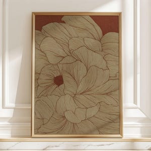 May include: A framed art print featuring a detailed floral design. The artwork showcases a close-up of stylized flowers with intricate line work in shades of gold and brown against a deep red background. The frame is gold.