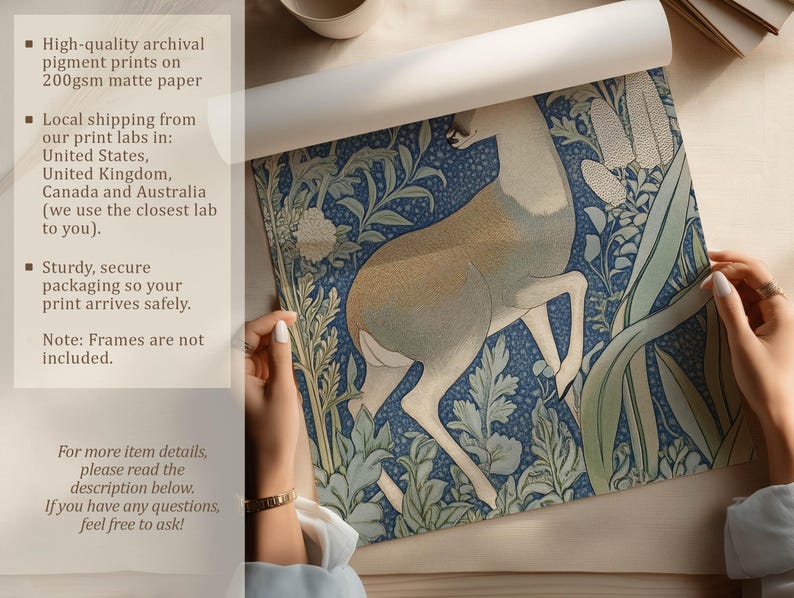 Detailed blue woodland deer botanical art print is being unrolled on a neutral tabletop by two hands, with text highlighting archival pigment inks and matte paper.