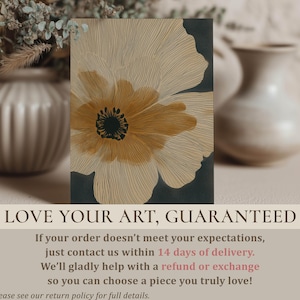 Elegant botanical wall art print showing a large line-drawn bloom in beige and charcoal with a golden center, modern calm style, on a styled tabletop with guarantee overlay.