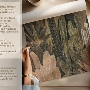 Olive-toned cactus composition with cream accents, art print being unrolled on a neutral tabletop by two hands with archival printing overlay.