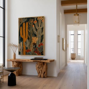 Stylized cactus wall art print in dark teal and yellow with floral accents, calming modern vibe; framed art print hanging above a sculptural live-edge wooden console with a black accent stool and glass pendant lights.