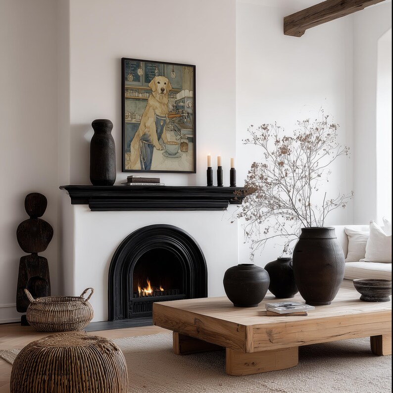 Cozy golden retriever wall art print in watercolor tones, framed above a black fireplace mantel in a neutral living room with a lit fire and woven accents.