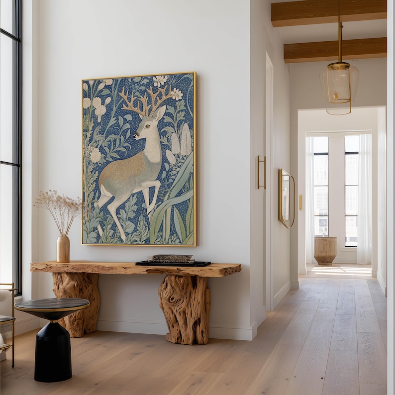 Graceful stag illustration in blue and tan tones with floral background wall art print hangs above a sculptural live-edge wooden console in a modern hallway.