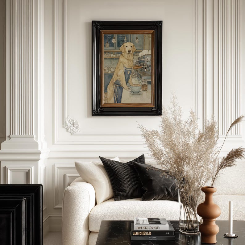 Framed dog art print in muted blue and beige hung on an ornate paneled wall above a cream sofa, styled with black cushions, pampas grass and warm ceramics.