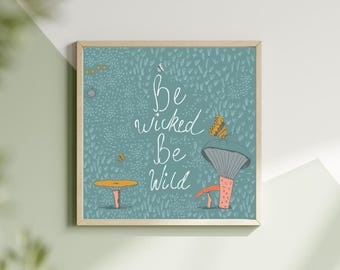 May include: A square framed wall art piece featuring a teal background with white text that reads Be wicked Be Wild. The illustration includes orange and grey mushrooms, small yellow dots, and a butterfly perched on a large mushroom cap.