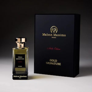 May include: A perfume bottle and box set. The bottle is rectangular with a gold cap and a black label that reads "GOLD SIGNATURE". The box is black with gold lettering that reads "Maison Massimo Paris" and "Gold Signature".