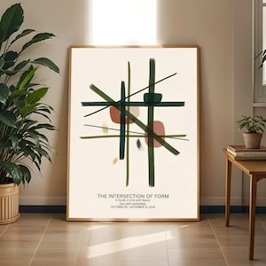 Può includere: Una stampa artistica incorniciata con un design astratto di linee verdi scure che si intersecano e forme color ruggine su uno sfondo crema. Il testo "THE INTERSECTION OF FORM" e altri dettagli sono stampati in basso. L'opera d'arte è esposta in una stanza con una pianta.
