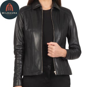 May include: A black leather jacket with a zipper closure, collared neckline, and long sleeves. The jacket has a tailored fit and is shown on a person. The Wildaura Jacket logo is in the upper left corner.