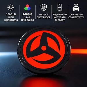 May include: A circular display device featuring a glowing red background with a black three-pronged shuriken-style graphic. Text icons above indicate 1000 nit high brightness, RGB888 24-bit true color, water and dust proof, iOS and Android app support, and car system connectivity.
