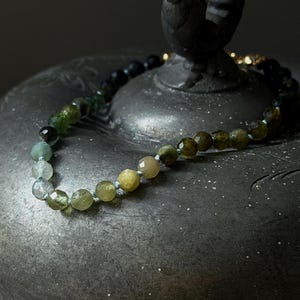 faceted ombré green tourmaline bracelet hand knotted on blue silk with gold filled clasp