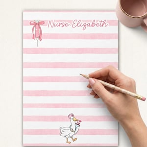 May include: Pink and white striped notepad with the text "Nurse Elizabeth" in pink script. A cartoon syringe and a goose wearing a nurse's hat are also featured. A hand is holding a pencil over the notepad.