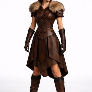 May include: A brown leather costume with a fur collar, short sleeves, and a knee-length skirt. The outfit includes matching gloves and tall boots. The costume has a medieval or fantasy theme.