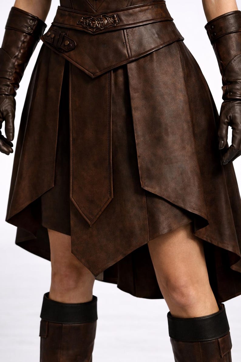 May include: A brown leather skirt with a layered, asymmetrical design. The skirt features a detailed belt and is paired with matching gloves and boots. The overall style suggests a medieval or fantasy theme.