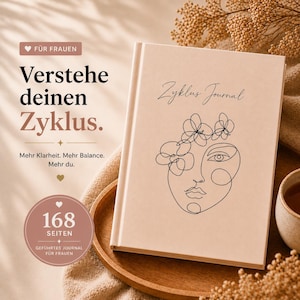 May include: A beige journal with the text "Zyklus Journal" and a line art face with floral accents. The cover also features the text "Verstehe deinen Zyklus" and "168 Seiten". The journal is on a wooden tray.