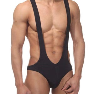 May include: Black singlet with suspender straps. The garment features a low-cut neckline and a form-fitting design. The straps extend over the shoulders, creating a distinctive silhouette. The fabric appears to be a smooth, solid color.