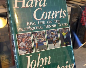 Pistas duras por John Feinstein / 1991 Primera edición Tapa dura Biografía de tenis