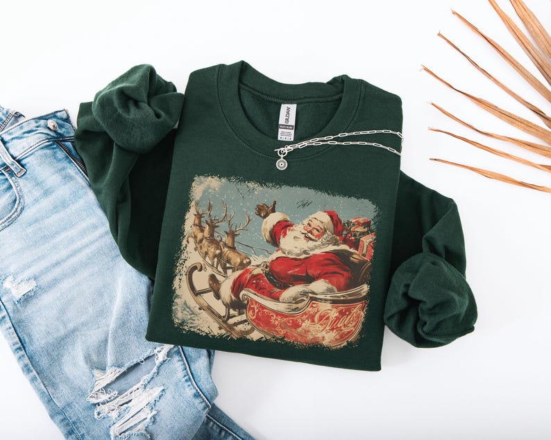 dark-green Christmas sweatshirt with vintage 60s Santa Claus riding sleigh and reindeer illustration; retro Santa Christmas sweater, classic holiday sweatshirt, cozy winter pullover, nostalgic Christmas design, unisex festive apparel, holiday gift idea, traditional Christmas aesthetic sweatshirt, matching family Christmas outfits.