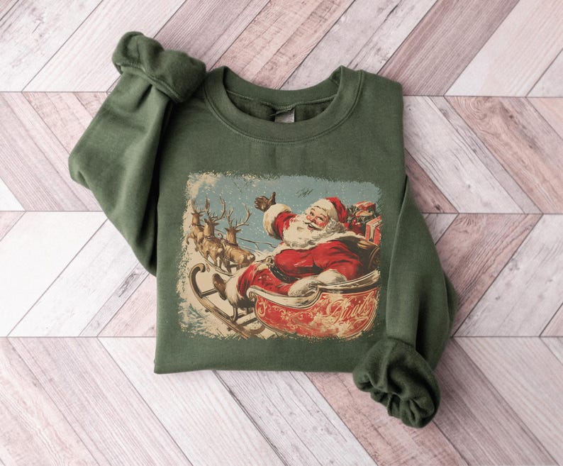 green Christmas sweatshirt with vintage 60s Santa Claus riding sleigh and reindeer illustration; retro Santa Christmas sweater, classic holiday sweatshirt, cozy winter pullover, nostalgic Christmas design, unisex festive apparel, holiday gift idea, traditional Christmas aesthetic sweatshirt, matching family Christmas outfits.