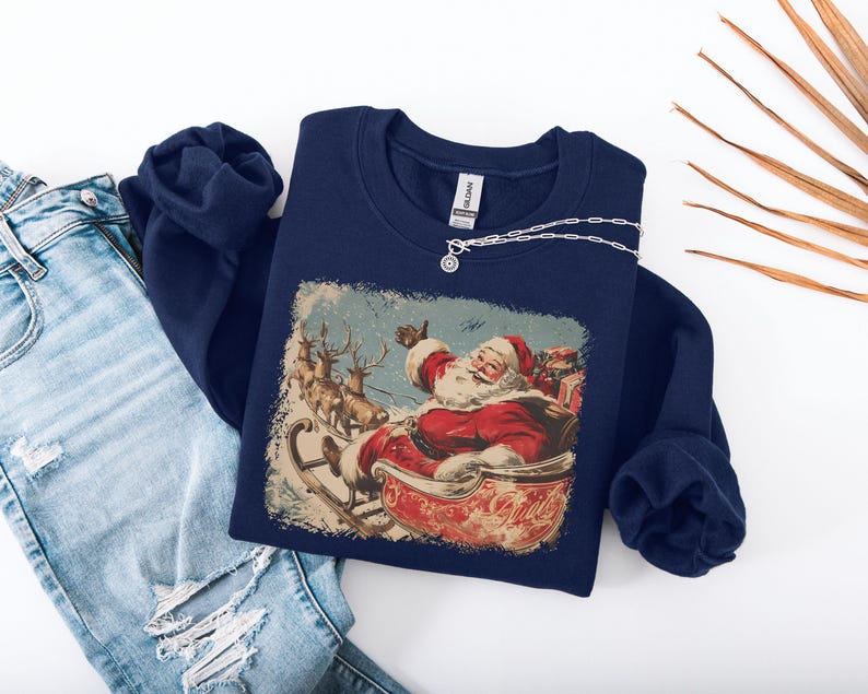 dark-blue Christmas sweatshirt with vintage 60s Santa Claus riding sleigh and reindeer illustration; retro Santa Christmas sweater, classic holiday sweatshirt, cozy winter pullover, nostalgic Christmas design, unisex festive apparel, holiday gift idea, traditional Christmas aesthetic sweatshirt, matching family Christmas outfits.