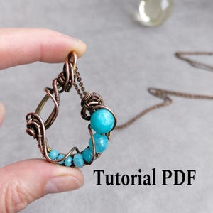 May include: A handcrafted copper wire pendant necklace with a teardrop shape. The pendant features a series of turquoise-colored beads and is suspended from a delicate chain. The text "Tutorial PDF" is visible at the bottom.