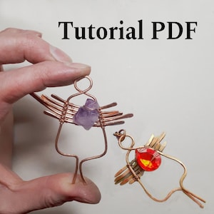 May include: Two handmade copper wire figures, one held by a hand, with gemstone accents. One figure features a purple amethyst, the other a red and yellow stone. The text "Tutorial PDF" is at the top.
