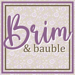 May include: Square graphic with the words "Brim & bauble" in a purple script font. The background is a floral pattern in light purple and beige. The text is framed by a purple border and a brown border.