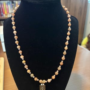 sunstone, pearl, and amber colored glass beaded necklace with gold bee pendant
