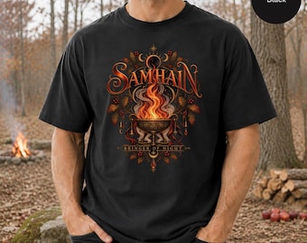 May include: A black t-shirt featuring a graphic print of a flaming cauldron with the text SAMHAIN and BRINGER OF NIGHT. The design includes orange and yellow flames, dark foliage, and crescent moon symbols centered on the chest of the garment.